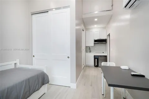 a spacious bedroom with a bed and a fireplace