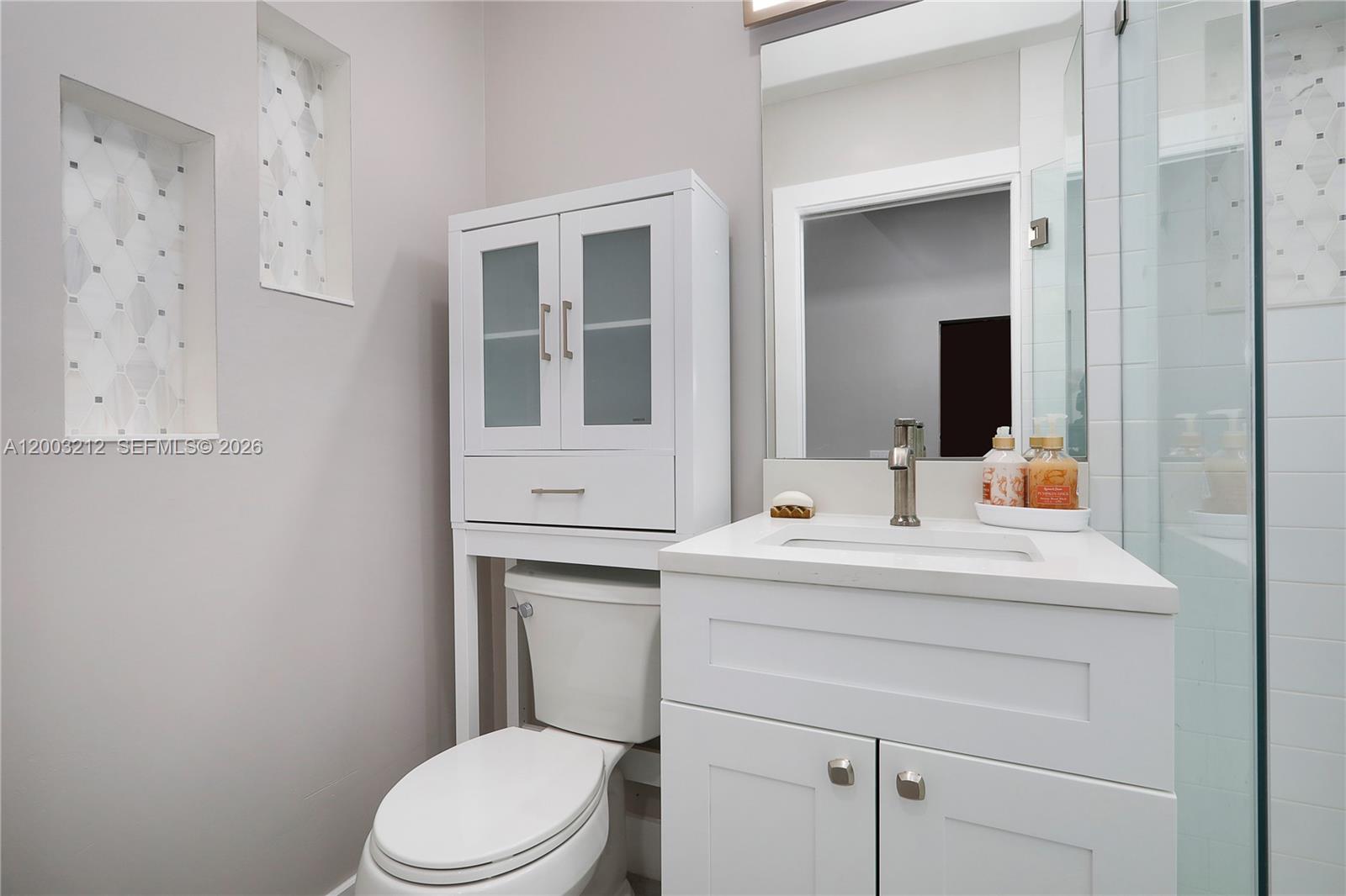 2368 Southwest 21st Street Miami, FL 33145 - Photo 7 of 8 a bathroom with a sink toilet vanity and mirror