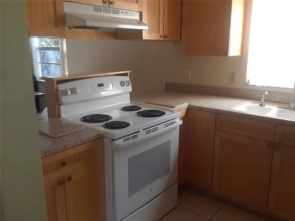 a kitchen with a stove and cabinets