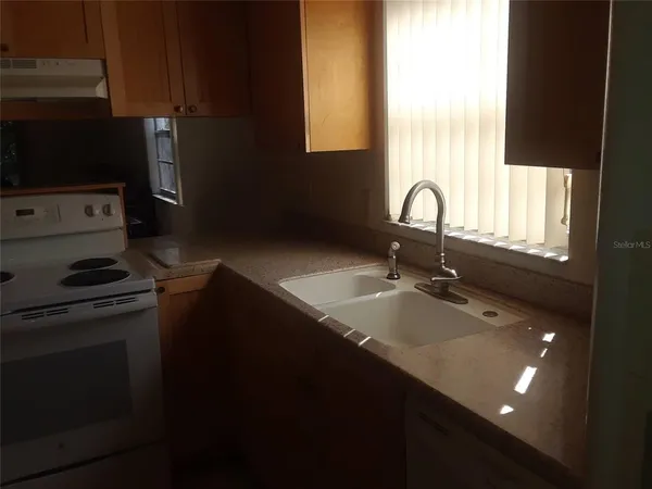 a kitchen with a sink appliances and cabinets