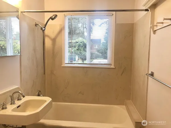 a bathroom with a shower and a sink