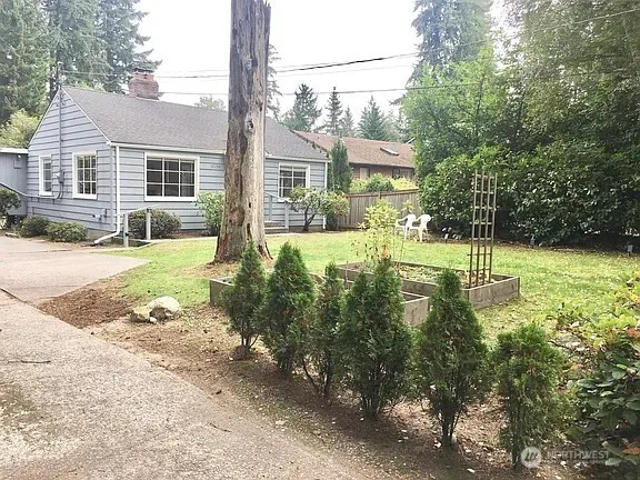 a view of a house with backyard and sitting area