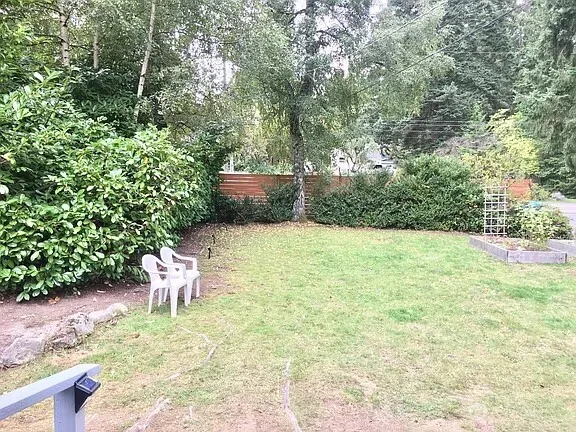 a view of a chairs and bench in the yard