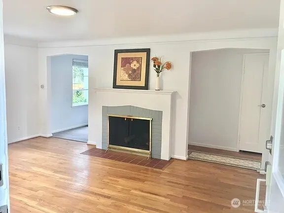 a view of a livingroom with a fireplace and window