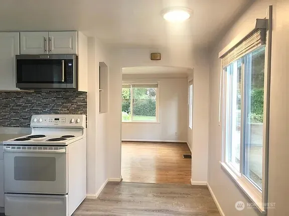 a view of kitchen with sink and electronic appliances