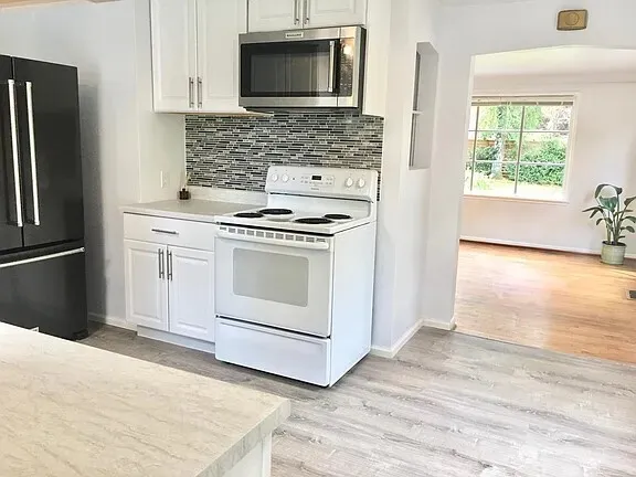 a kitchen with a stove microwave and sink