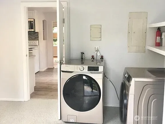 a view of a storage and utility room with washer and dryer
