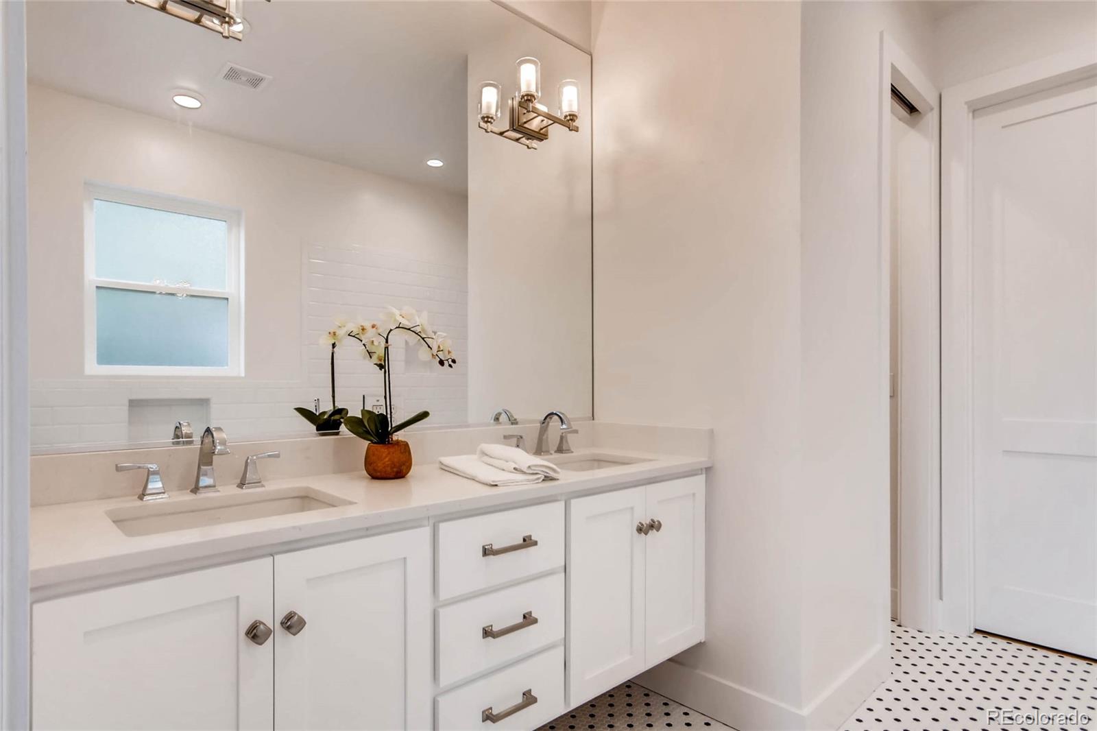 2136 Lowell Boulevard Denver, CO 80211 - Photo 11 of 23 a bathroom with 2 sink and a mirror