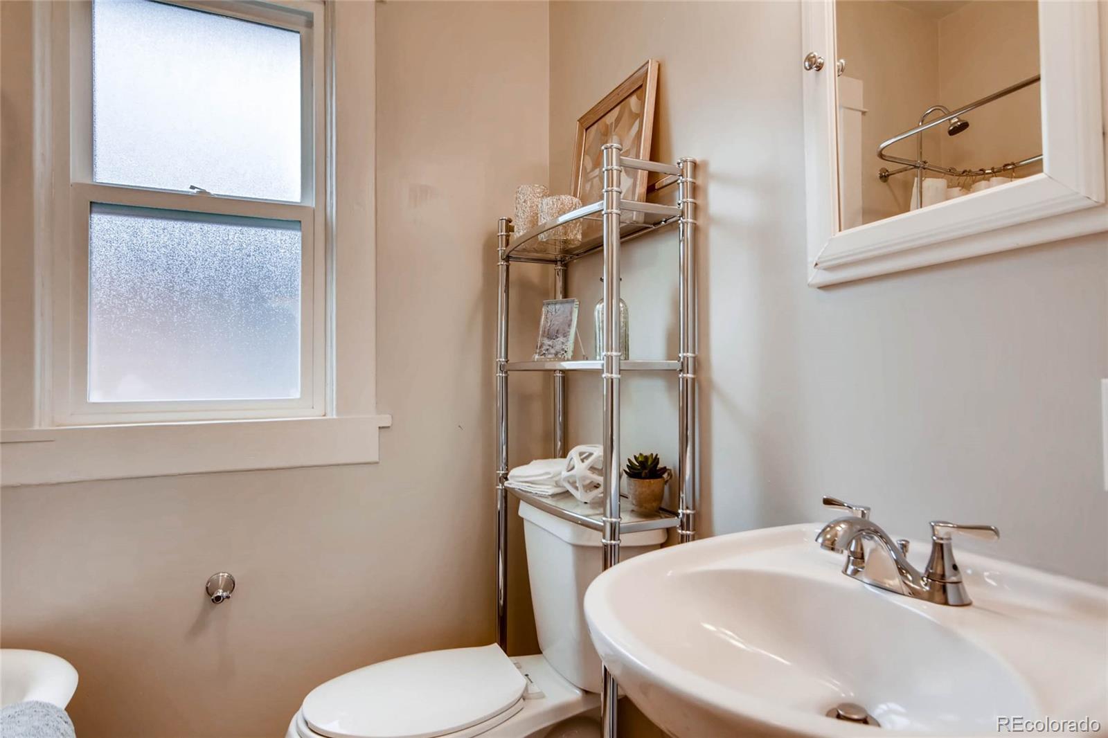 2136 Lowell Boulevard Denver, CO 80211 - Photo 14 of 23 a bathroom with a sink and a toilet