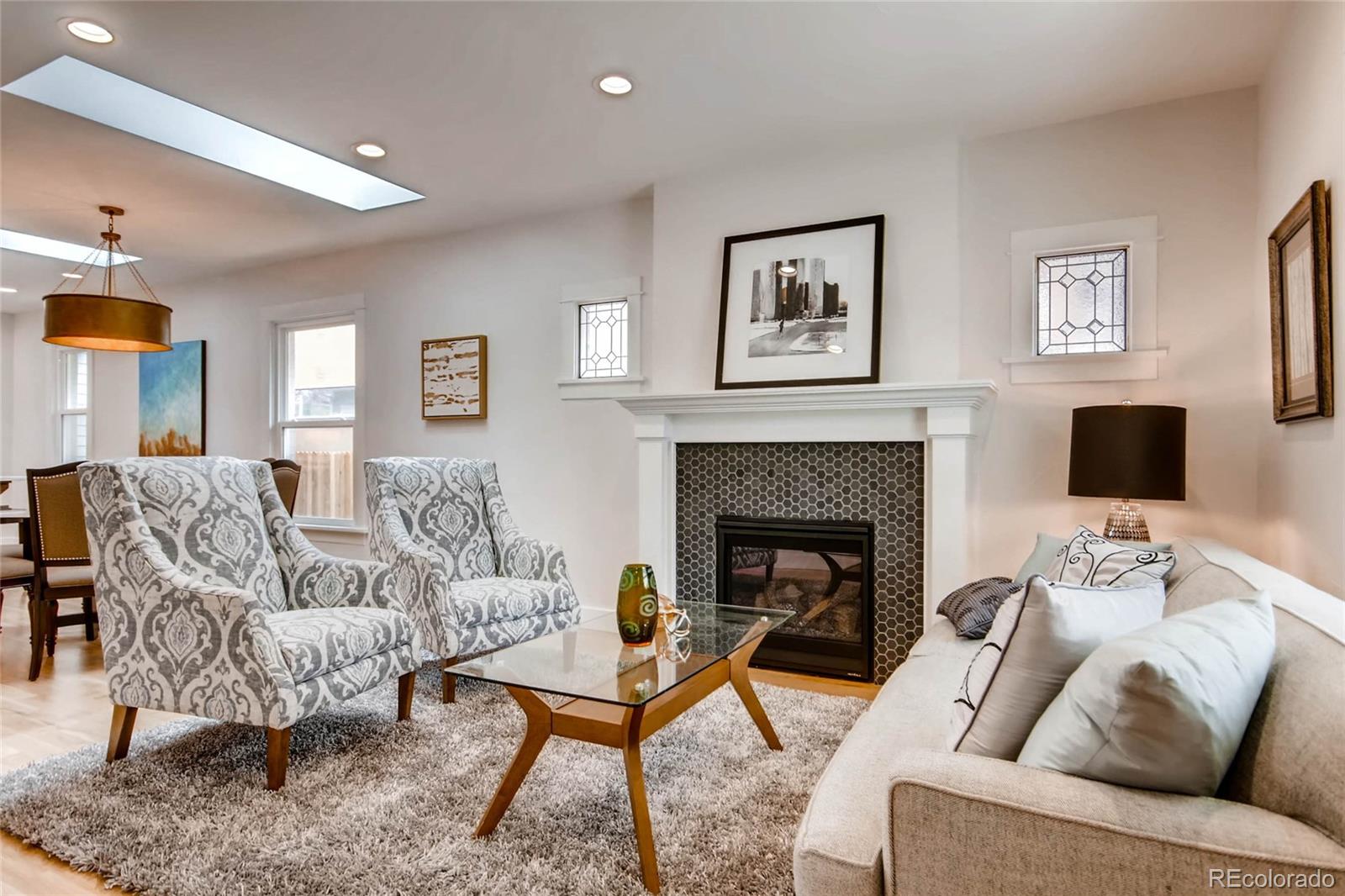 2136 Lowell Boulevard Denver, CO 80211 - Photo 2 of 23 a living room with furniture and a fireplace