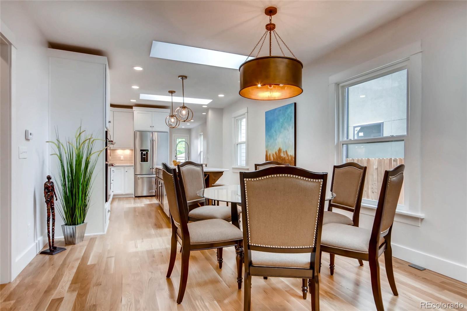 2136 Lowell Boulevard Denver, CO 80211 - Photo 4 of 23 a dining room with furniture a chandelier and wooden floor