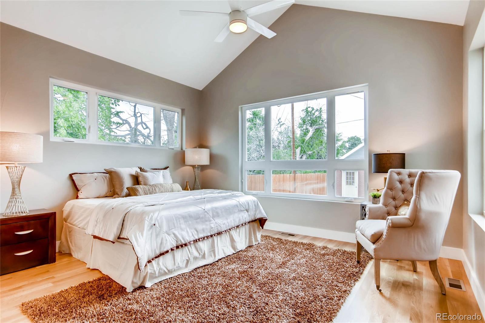 2136 Lowell Boulevard Denver, CO 80211 - Photo 8 of 23 a bedroom with a bed and a large window