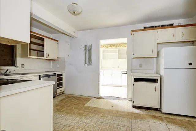 a kitchen with a stove a sink and a refrigerator