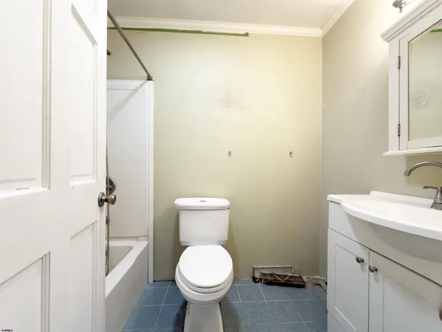 a bathroom with a sink toilet and a mirror