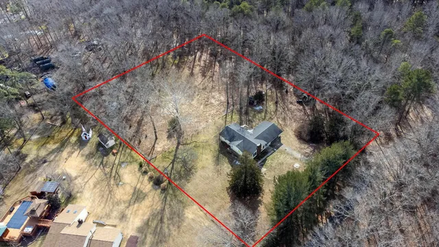 a brick house with trees in front of it