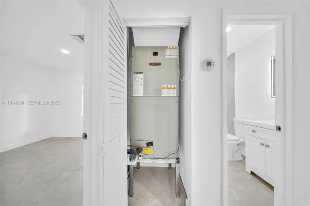 a view of a hallway with bathroom