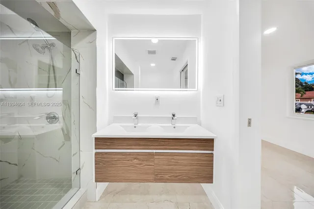 a bathroom with a shower and a glass door