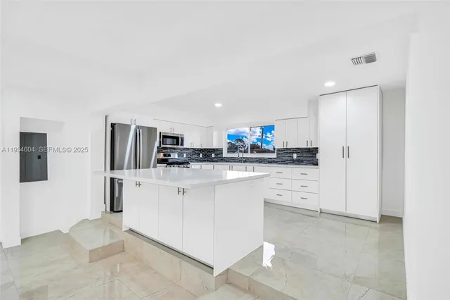 a kitchen with stainless steel appliances a refrigerator stove and microwave