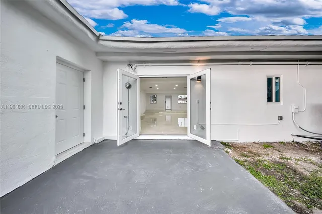 a view of a house with a backyard and a patio