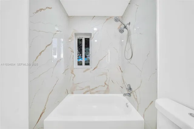 a bathroom with a bathtub and shower