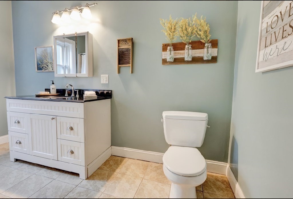 58 Waldo Street Dedham, MA 02026 - Photo 15 of 39 a bathroom with a toilet a sink and mirror