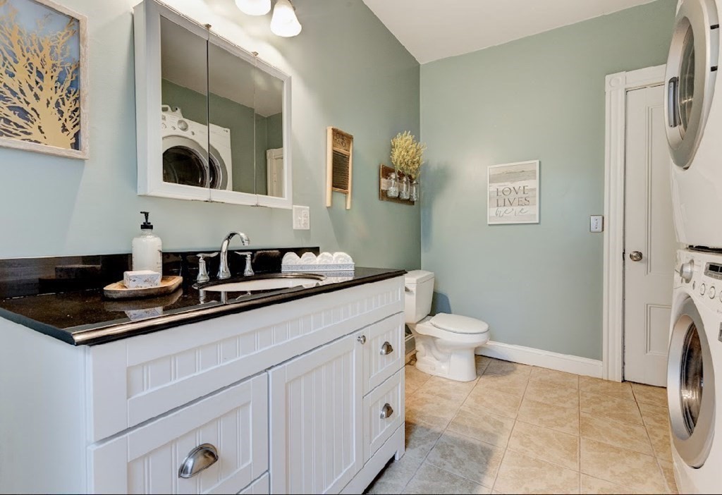 58 Waldo Street Dedham, MA 02026 - Photo 16 of 39 a bathroom with a toilet a sink and mirror