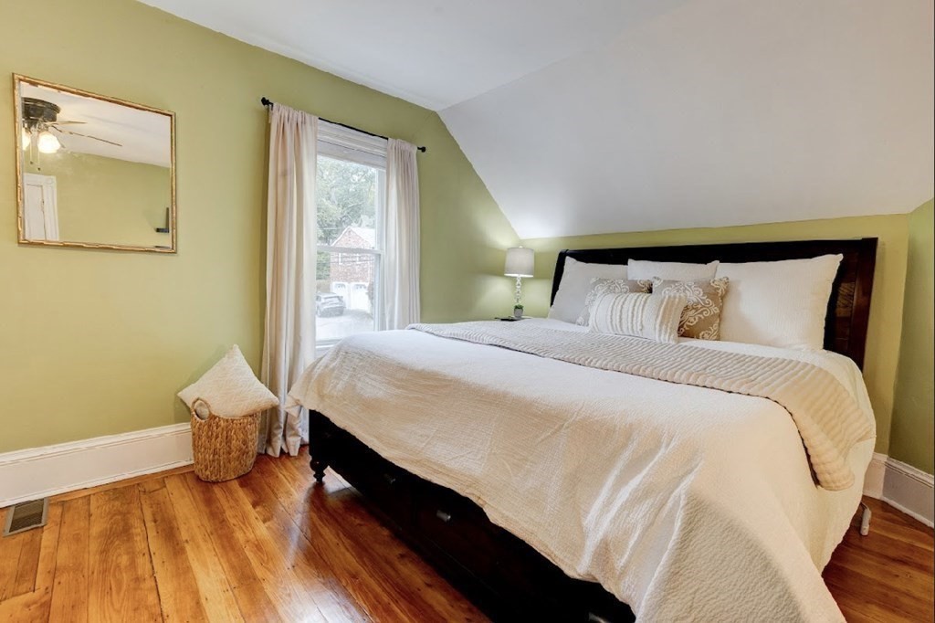 58 Waldo Street Dedham, MA 02026 - Photo 18 of 39 a bedroom with a bed and wooden floor