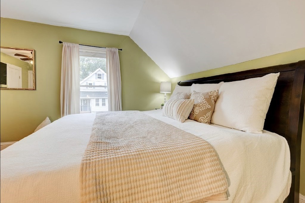 58 Waldo Street Dedham, MA 02026 - Photo 19 of 39 a bed sitting in a bedroom next to a window