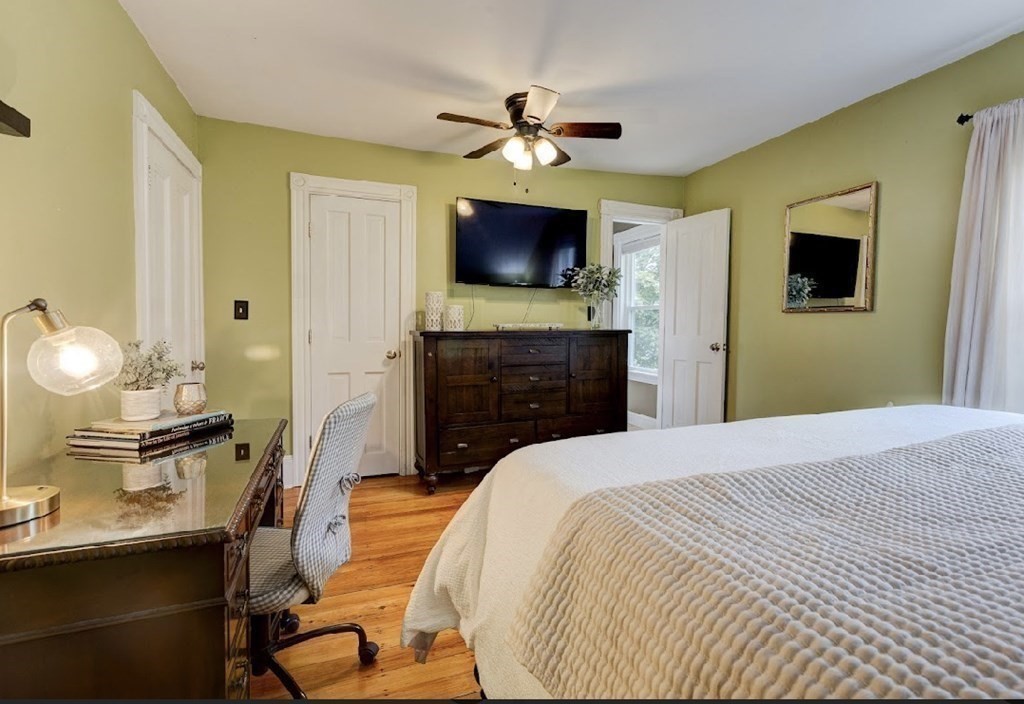 58 Waldo Street Dedham, MA 02026 - Photo 20 of 39 a bedroom with a bed and a flat screen tv