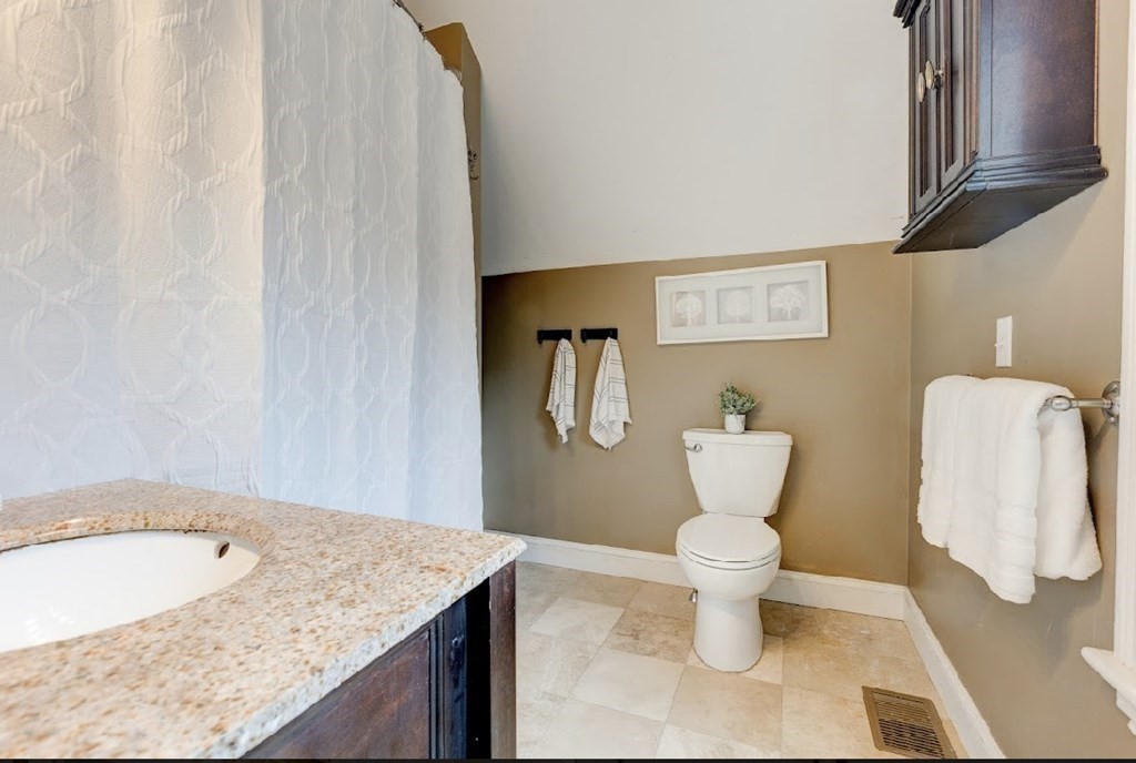58 Waldo Street Dedham, MA 02026 - Photo 22 of 39 a bathroom with a sink and toilet