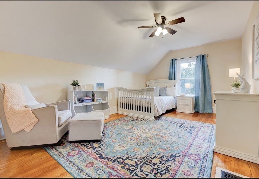 58 Waldo Street Dedham, MA 02026 - Photo 27 of 39 a bedroom with furniture and a chandelier