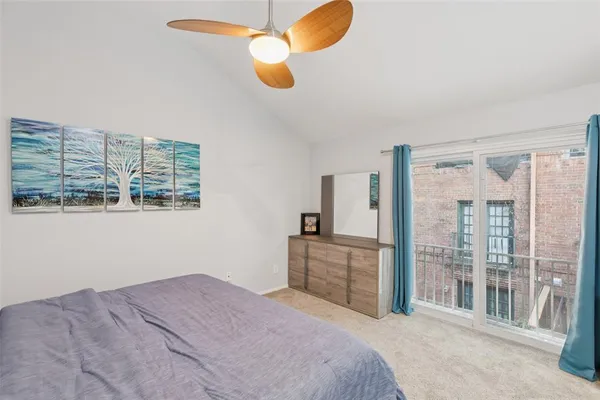 a bedroom with a large bed and chandelier