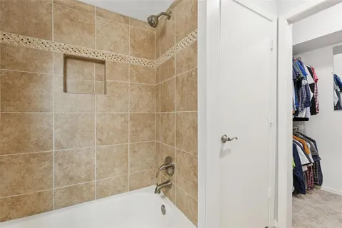 a bathroom with a tub and a shower