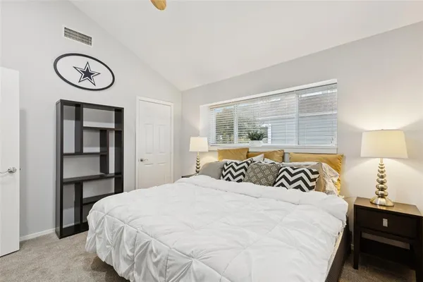 a bedroom with a bed and a window