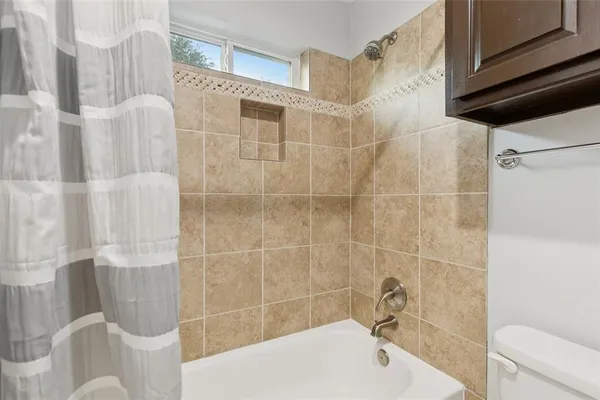 a bathroom with a shower and a sink
