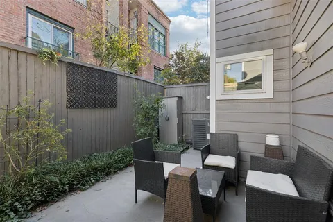 a backyard of a house with outdoor seating