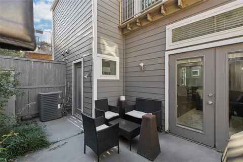 a backyard of a house with outdoor seating