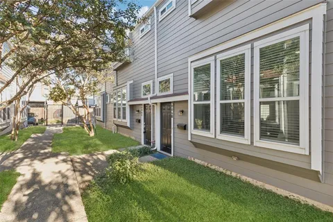 a view of house with backyard space and garden