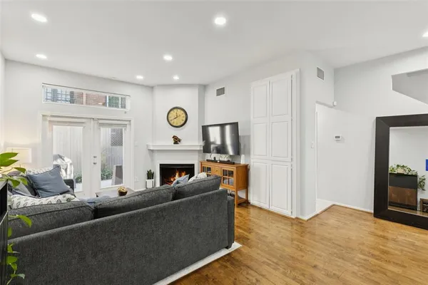 a living room with furniture a fireplace and a flat screen tv
