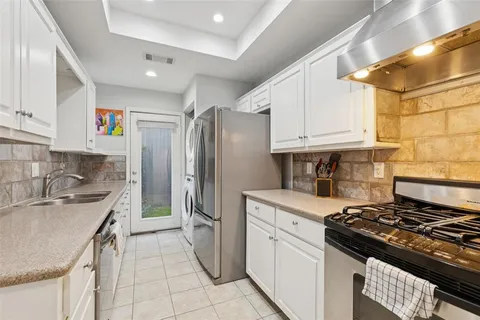 a kitchen with a stove a sink and a refrigerator
