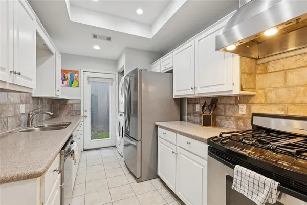 a kitchen with a stove a sink and a refrigerator