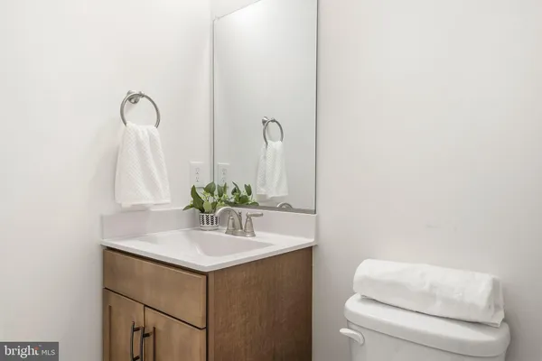 a bathroom with a sink vanity and toilet