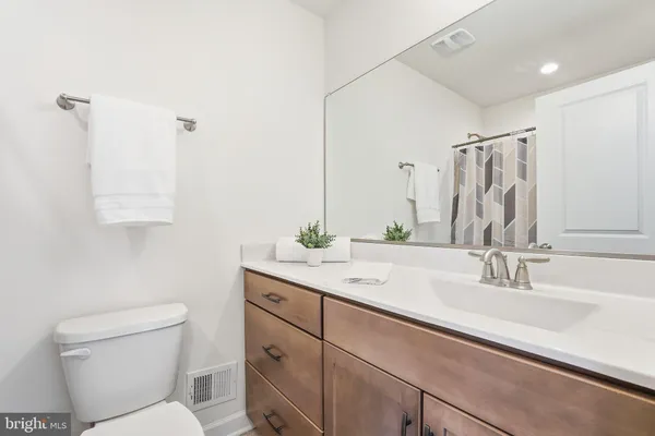 a view of a hallway with wooden floor and entryway