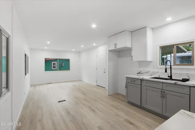 a kitchen with a sink stainless steel appliances and cabinets