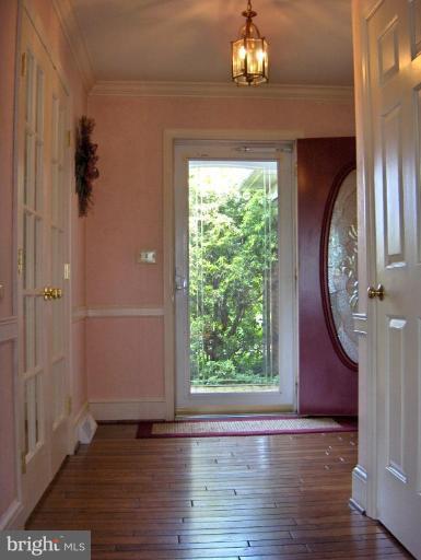 15119 Clear Spring Road Williamsport, MD 21795 - Photo 14 of 30 an empty room with wooden floor chandelier and windows