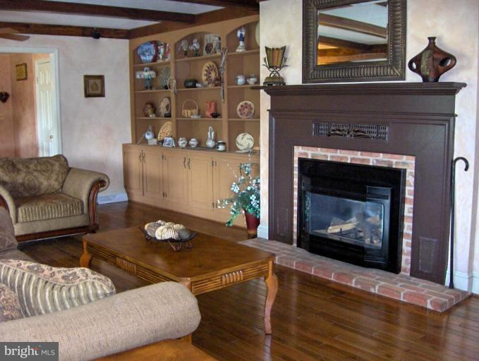 15119 Clear Spring Road Williamsport, MD 21795 - Photo 16 of 30 a living room with furniture and a fireplace