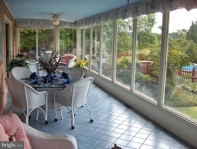 15119 Clear Spring Road Williamsport, MD 21795 - Photo 19 of 30 a dining room with furniture and floor to ceiling windows