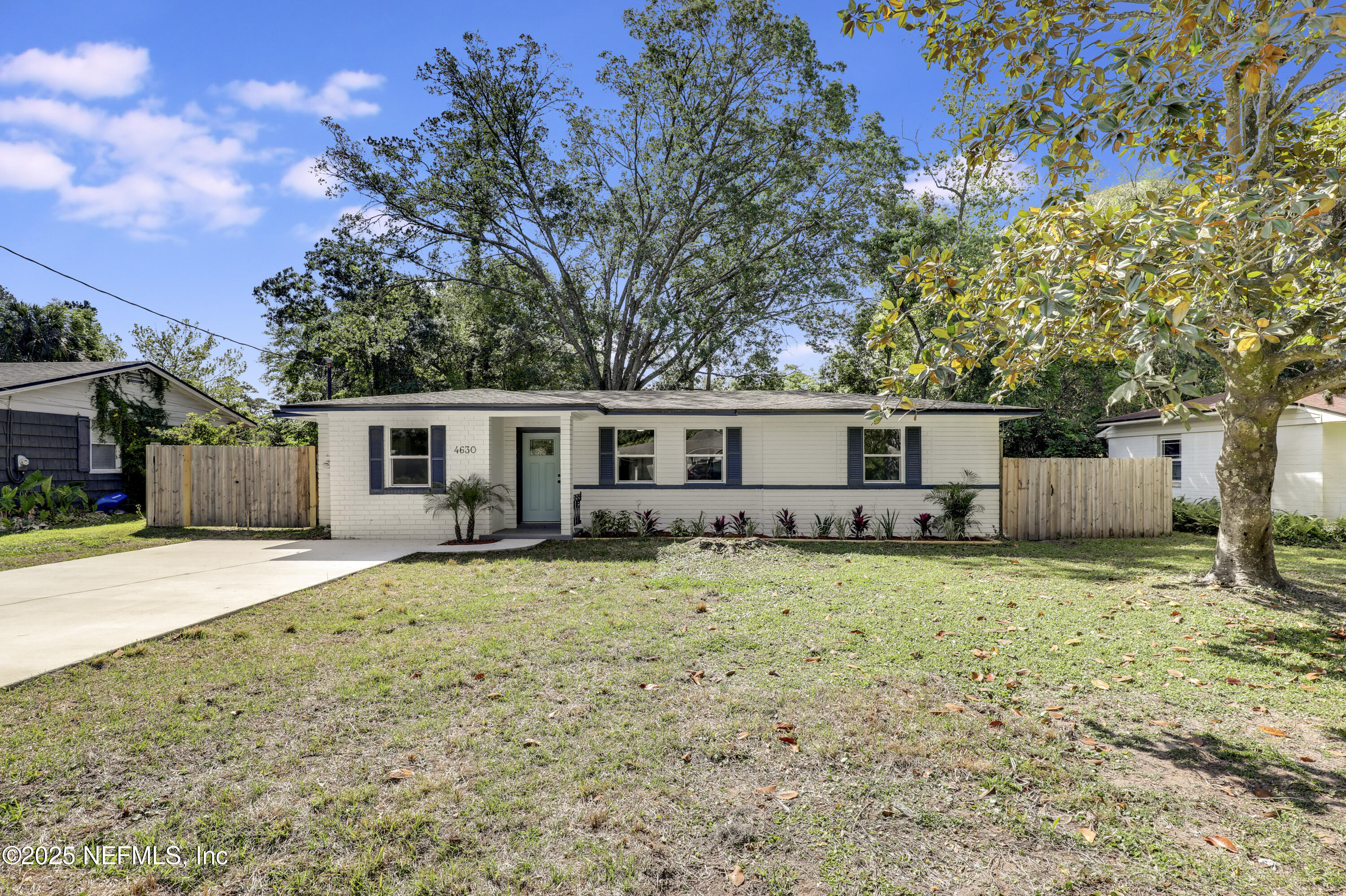 4630 Homestead Road Jacksonville, FL 32210 - Photo 1 of 45 a backyard of a house with table and chairs