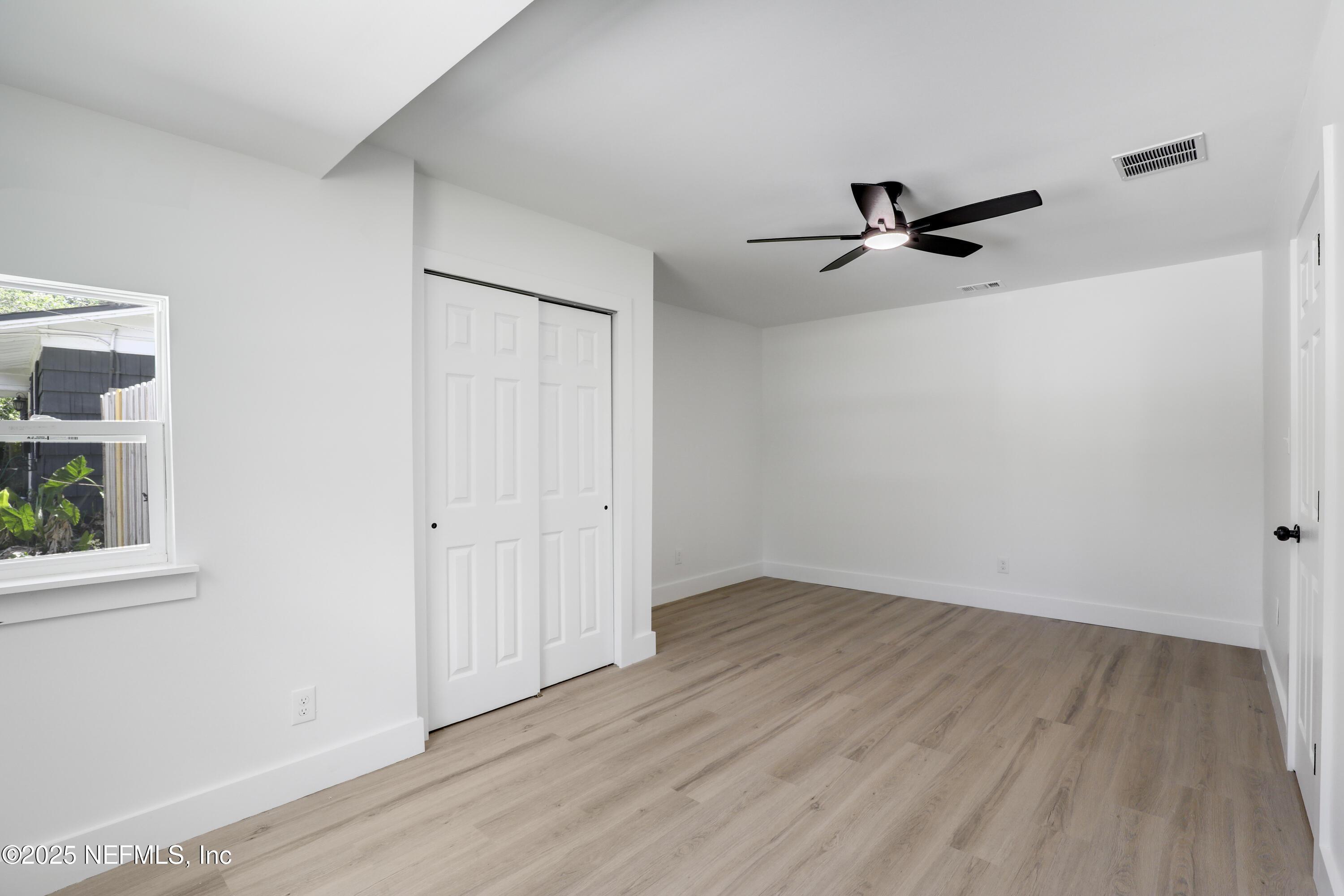 4630 Homestead Road Jacksonville, FL 32210 - Photo 13 of 45 a view of empty room with wooden floor and fan