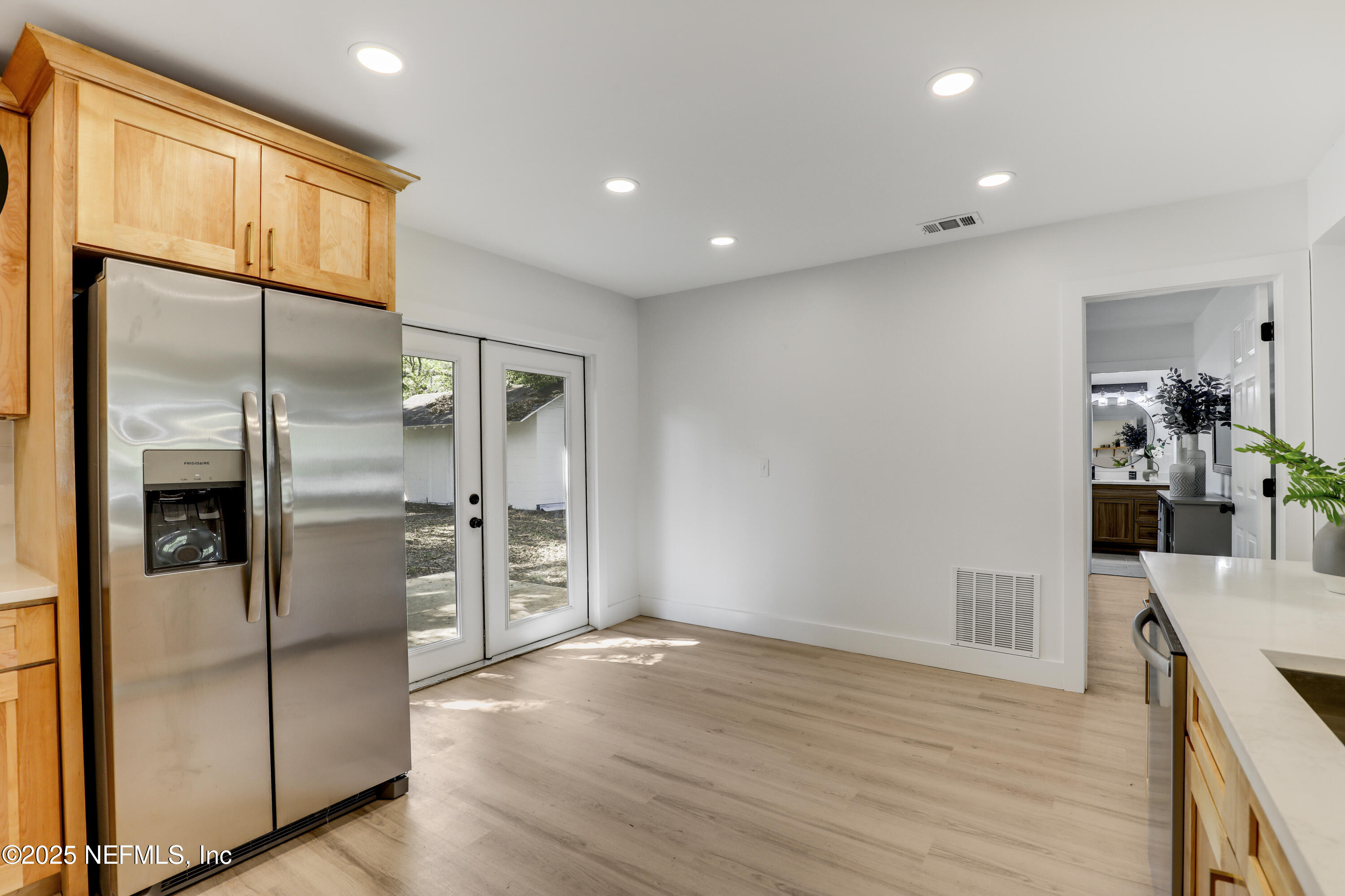 4630 Homestead Road Jacksonville, FL 32210 - Photo 21 of 45 a view of a kitchen with refrigerator and wooden floor